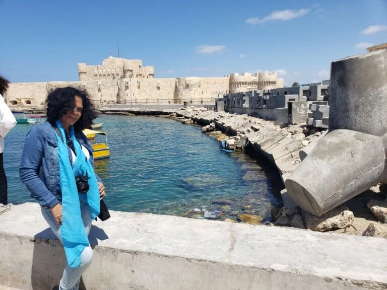 A person posing at the Qaitbay Fortress in Alexandria Egypt
