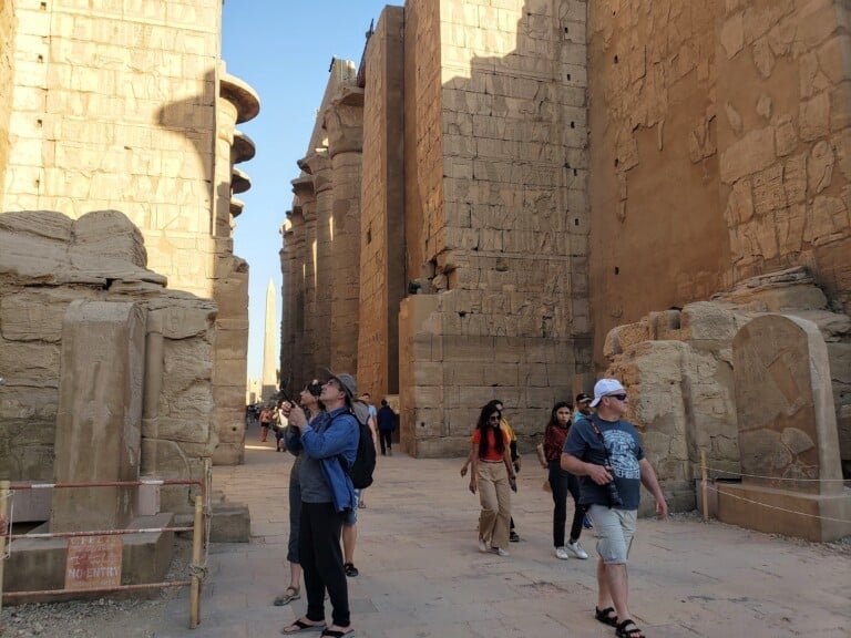 Traveleres admiring the monuments at Karnax Temple in Southern Egypt