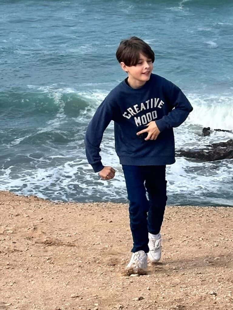 A kid walking on the beach at Souss Massa National Park