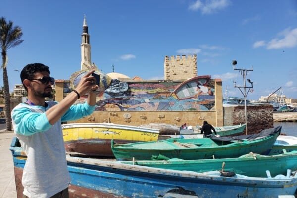 A person taking a photo in Alexandria Egypt