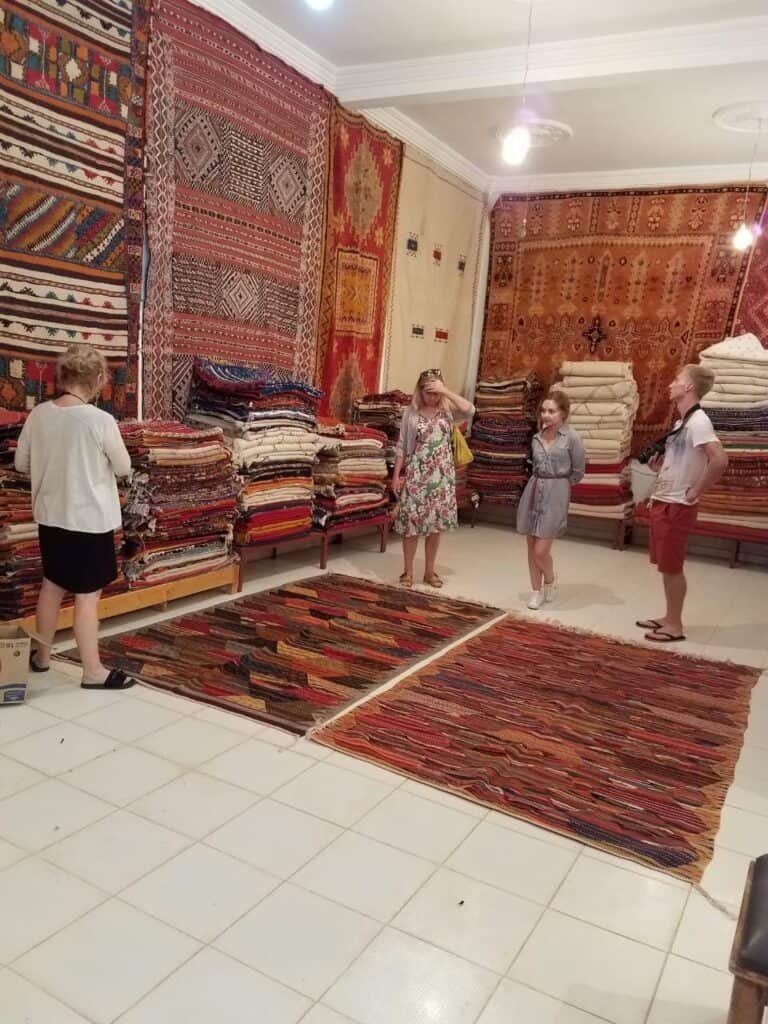 Four travelers at a carpet exibition in Fes