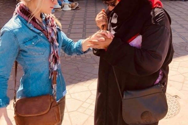 Marrakech tourist getting a hand henna tatoo