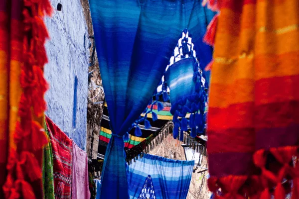 View of Moroccan carpets and colorful textiles in Chefchaouen Blue city, Morocco