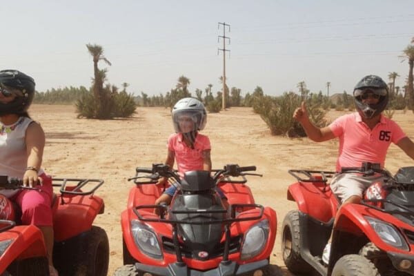 Three persons riding quad bikes at the Marrakech Palmeraie