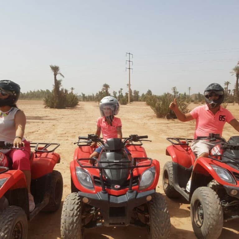 Three persons riding quad bikes at the Marrakech Palmeraie