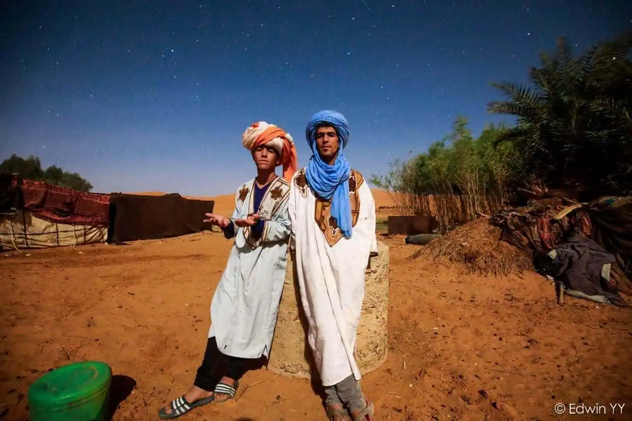 Two Moroccan men in local attire at Sahara Desert