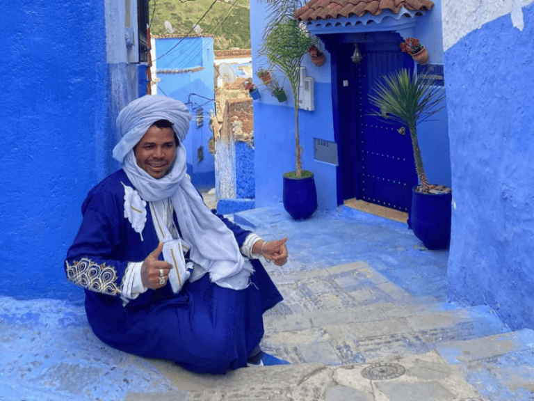A Moroccan man wearing a traditional outfit in Chefchaouen, Morocco