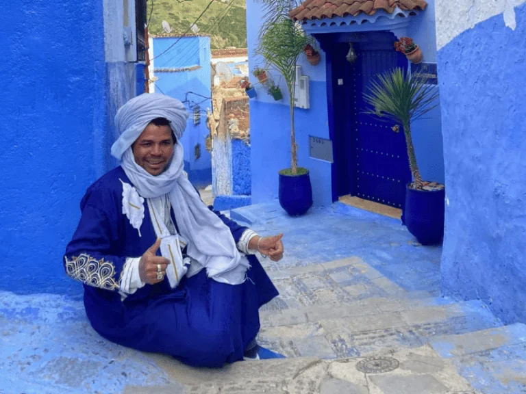 A Moroccan man wearing a traditional outfit in Chefchaouen, Morocco
